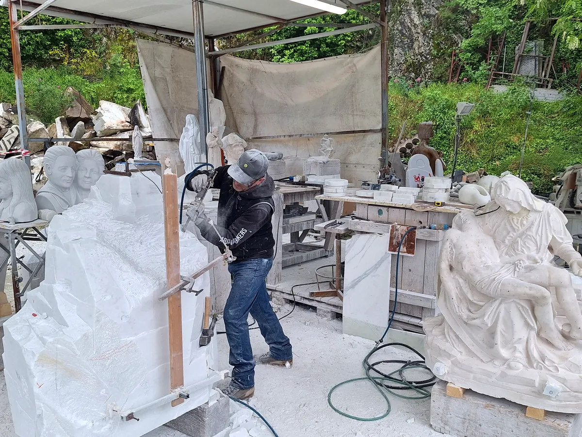 marble artisan working sculpture in Carrara workshop Italy